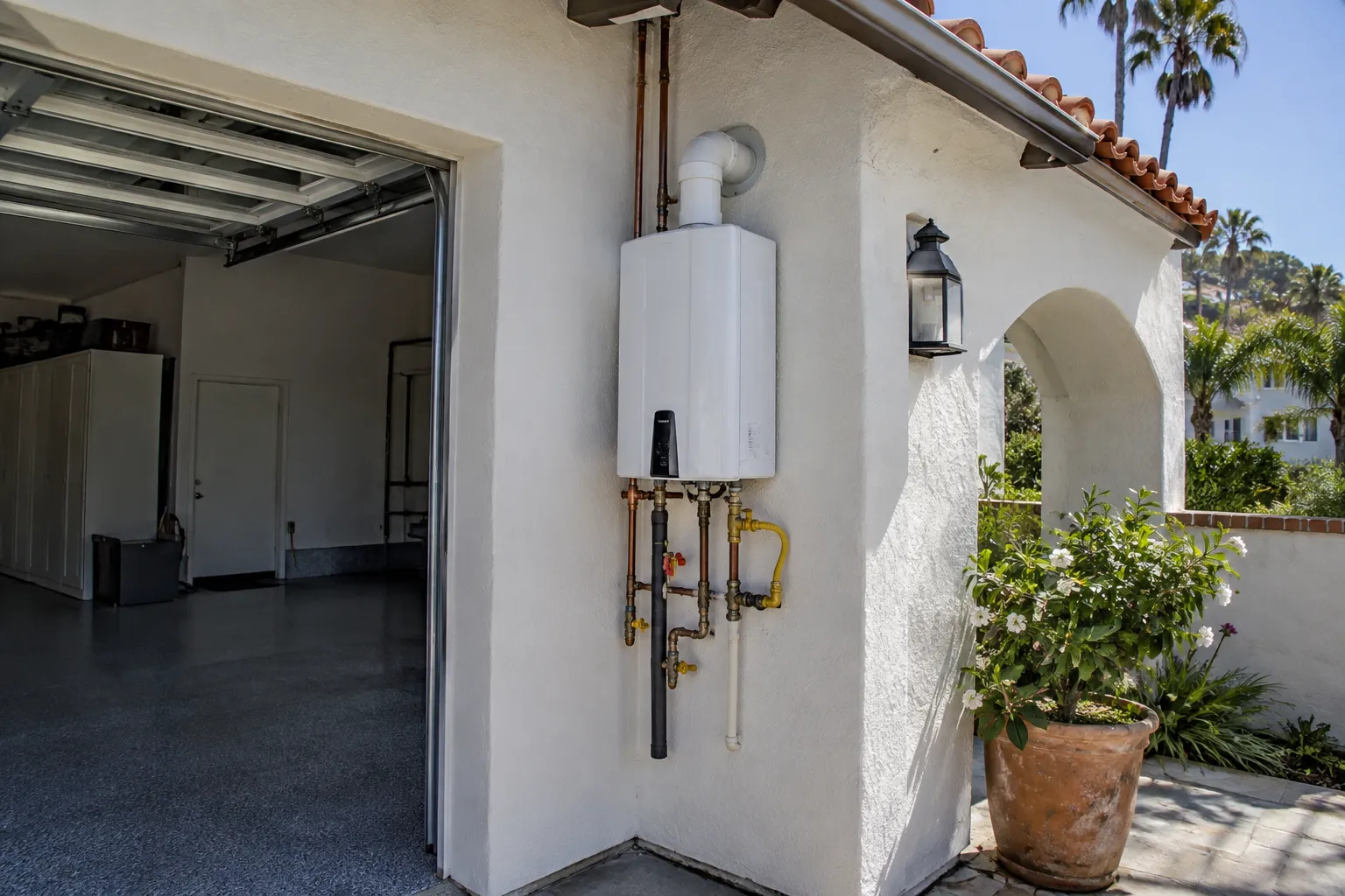 Wall-mounted tankless water heater installed in a San Clemente garage